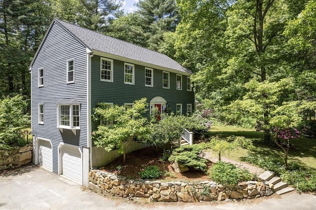92 Clinton St, Hopkinton, MA 01748 - colonial-style house with an attached garage, asphalt driveway, and roof with shingles