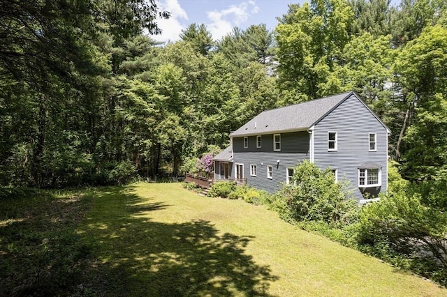 92 Clinton St, Hopkinton, MA 01748 - view of grassy yard with a deck and a view of trees