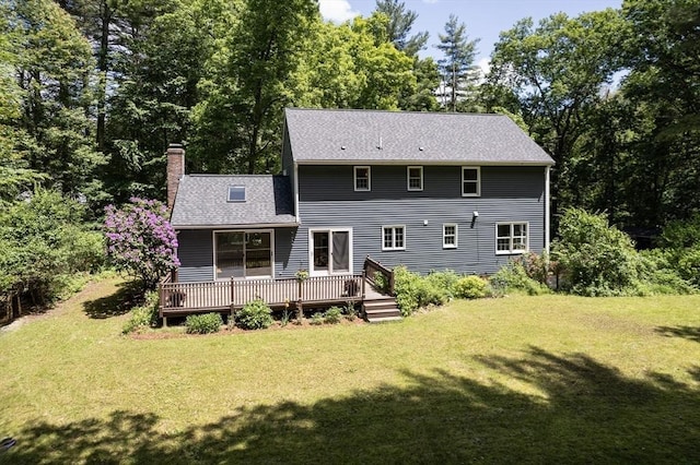 92 Clinton St, Hopkinton, MA 01748 - rear view of house with a chimney, a lawn, a deck, and a shingled roof