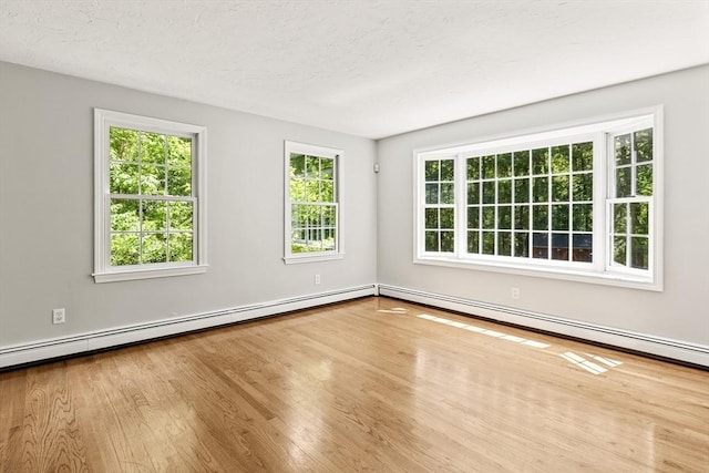 92 Clinton St, Hopkinton, MA 01748 - unfurnished room with wood finished floors and a baseboard radiator