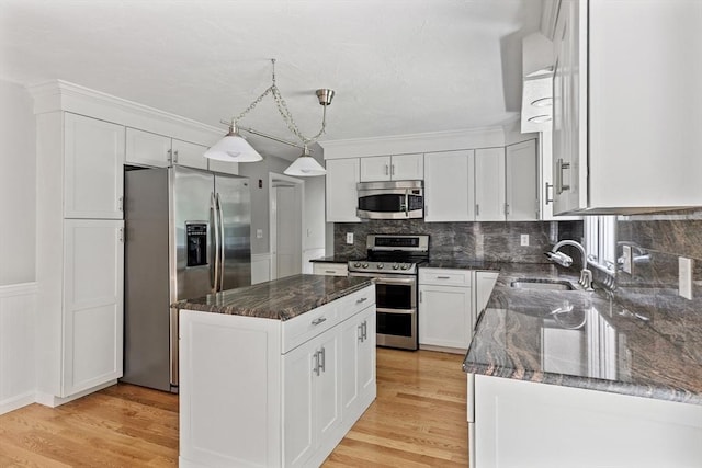 92 Clinton St, Hopkinton, MA 01748 - kitchen featuring stainless steel appliances, a kitchen island, tasteful backsplash, dark stone countertops, and white cabinets