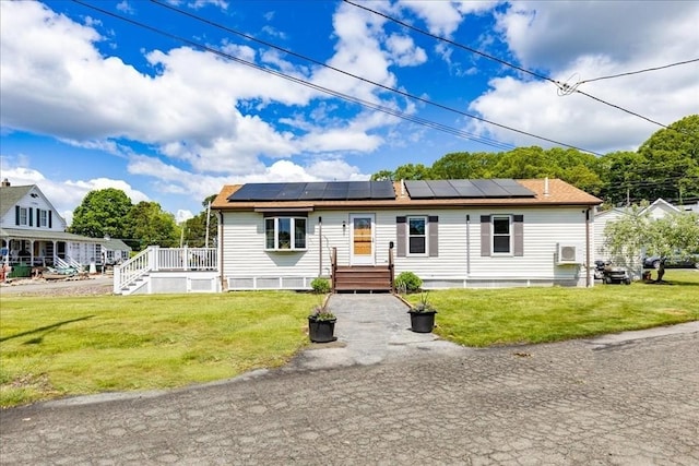 1 Shore Ave, Beverly, MA 01915 - view of front of house featuring roof mounted solar panels and a front lawn