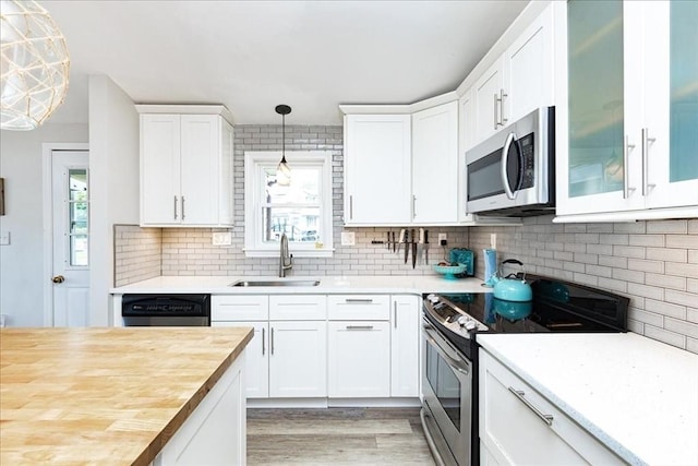 1 Shore Ave, Beverly, MA 01915 - kitchen with stainless steel appliances, a sink, plenty of natural light, and wooden counters
