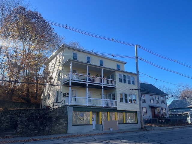 back of property featuring a balcony