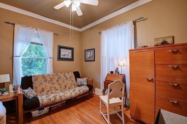 sitting room with crown molding, ceiling fan, and light wood-type flooring