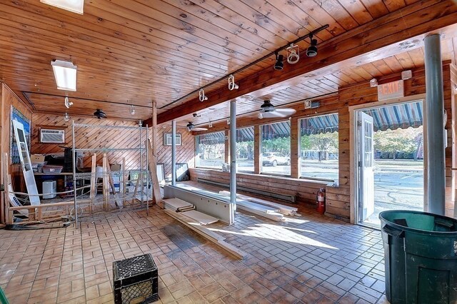 interior space featuring track lighting, ceiling fan, and wooden ceiling