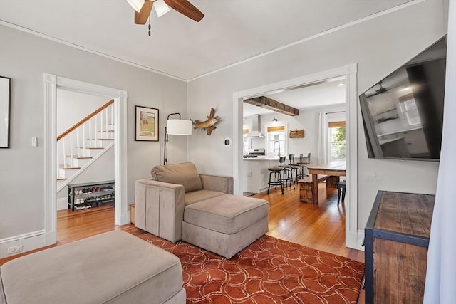 11 Draper Rd, Framingham, MA 01702 - living area with wood finished floors, a ceiling fan, and stairway