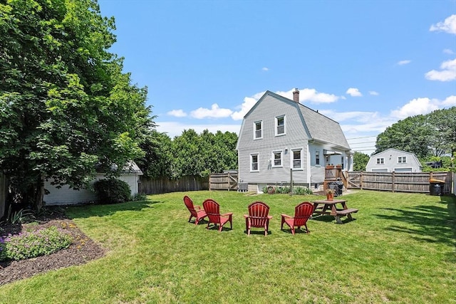 11 Draper Rd, Framingham, MA 01702 - rear view of house with a chimney, a fenced backyard, and a gambrel roof