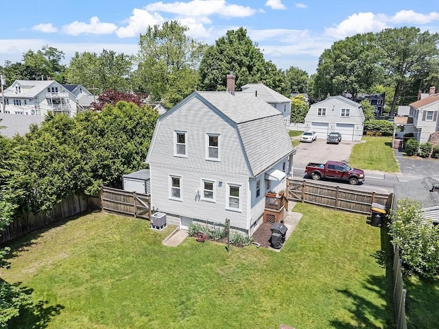 11 Draper Rd, Framingham, MA 01702 - back of house with a gambrel roof, a chimney, and a fenced backyard