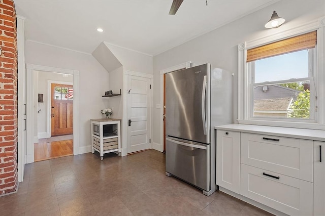 11 Draper Rd, Framingham, MA 01702 - kitchen featuring freestanding refrigerator, light countertops, white cabinetry, recessed lighting, and crown molding