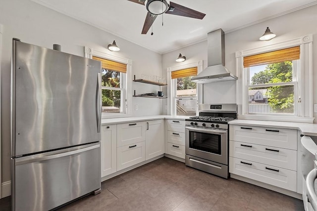 11 Draper Rd, Framingham, MA 01702 - kitchen featuring stainless steel appliances, wall chimney exhaust hood, light countertops, white cabinets, and ornamental molding