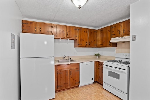 kitchen with tasteful backsplash, a textured ceiling, white appliances, sink, and light parquet flooring