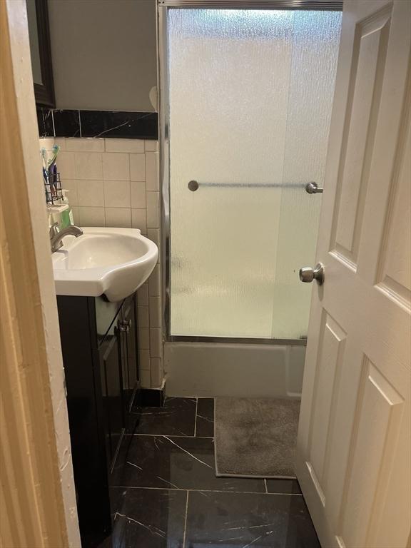 9 Cedar St, Lynn, MA 01905 - full bathroom with vanity, tile patterned flooring, and tile walls
