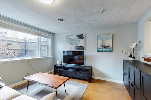 carpeted living room featuring a textured ceiling