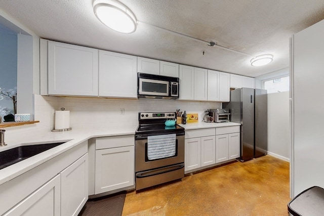 kitchen with sink, a textured ceiling, appliances with stainless steel finishes, tasteful backsplash, and white cabinetry