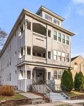 traditional style home featuring a balcony