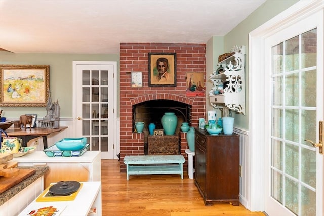 sitting room featuring light hardwood / wood-style floors and a fireplace