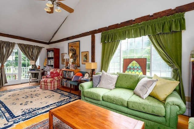 living room with ceiling fan, hardwood / wood-style flooring, a baseboard radiator, and high vaulted ceiling