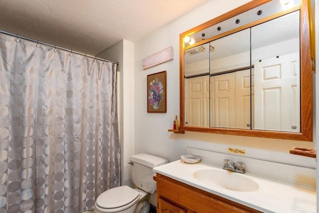 bathroom featuring toilet, vanity, and a shower with shower curtain