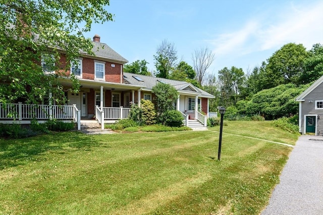 view of front of house with a front yard and covered porch