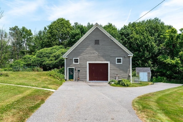 view of side of property featuring a storage shed and a lawn