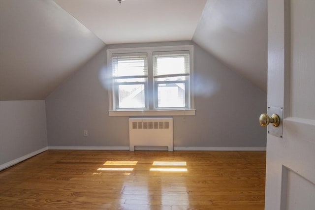 33 Altoona Rd, Dedham, MA 02026 - additional living space featuring radiator heating unit, wood finished floors, vaulted ceiling, and baseboards