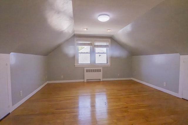 33 Altoona Rd, Dedham, MA 02026 - bonus room with radiator, wood finished floors, vaulted ceiling, and baseboards