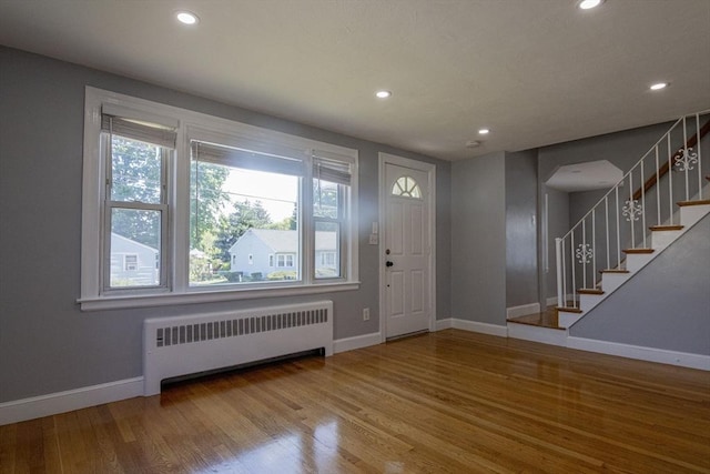 33 Altoona Rd, Dedham, MA 02026 - entryway featuring radiator, baseboards, recessed lighting, wood finished floors, and stairway