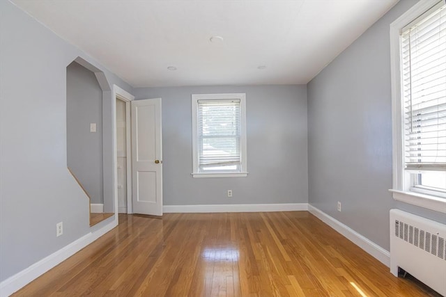33 Altoona Rd, Dedham, MA 02026 - unfurnished room with radiator heating unit, light wood-type flooring, and baseboards