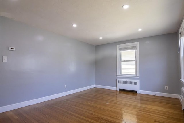 33 Altoona Rd, Dedham, MA 02026 - unfurnished room with radiator heating unit, baseboards, wood finished floors, and recessed lighting