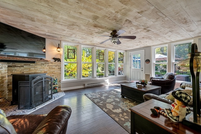 living room featuring a fireplace, ceiling fan, dark wood-type flooring, and a baseboard radiator