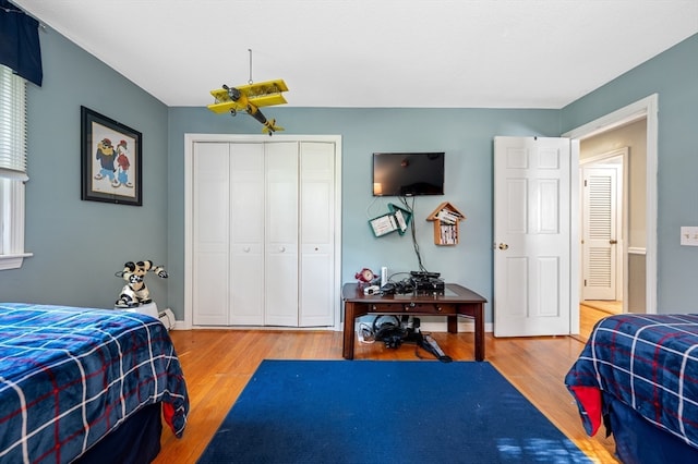 bedroom with hardwood / wood-style flooring and a closet