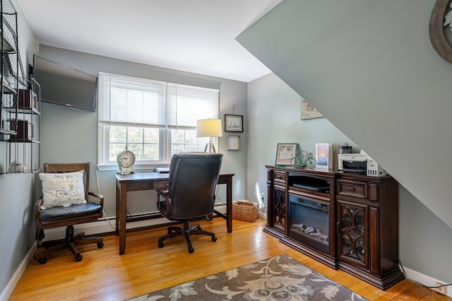 office area with light hardwood / wood-style floors