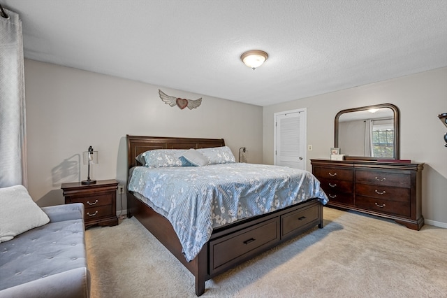 carpeted bedroom with a textured ceiling