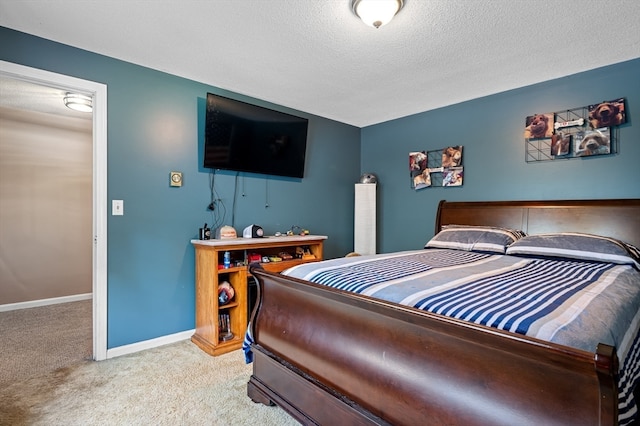 bedroom featuring a textured ceiling and light carpet