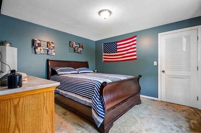 bedroom with a textured ceiling and carpet