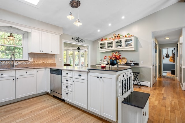 kitchen with white cabinetry, stainless steel dishwasher, plenty of natural light, and sink