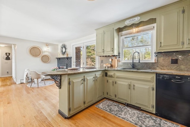 kitchen with dishwasher, a peninsula, plenty of natural light, and a sink