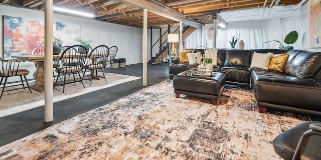 living room with stairs and concrete floors