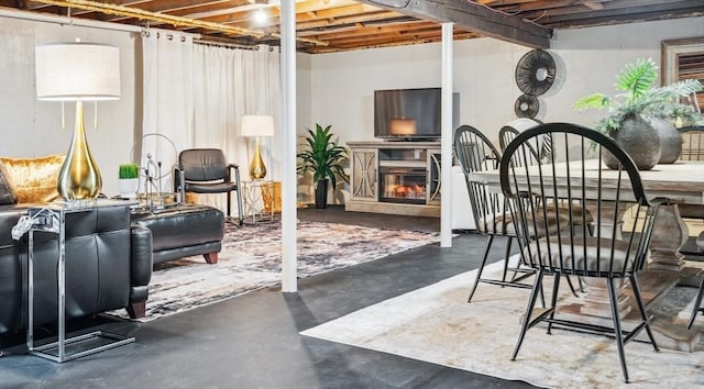 unfinished basement with a glass covered fireplace