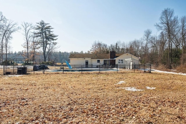 view of yard with a pool and fence