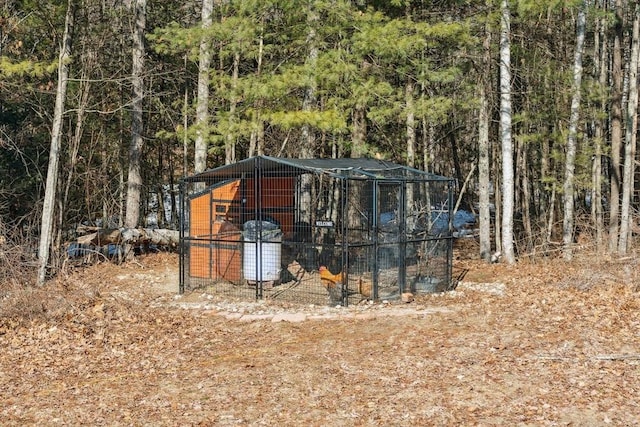 view of poultry coop featuring a wooded view