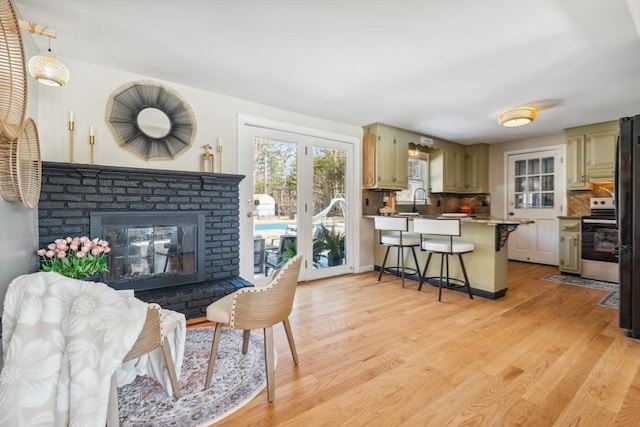 living room featuring a fireplace and light wood-type flooring