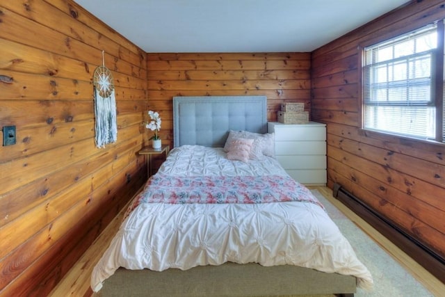 carpeted bedroom featuring wooden walls and a baseboard radiator