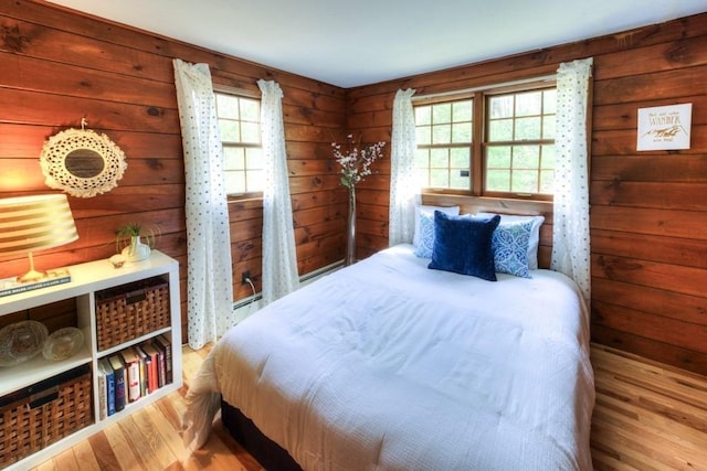 bedroom with wooden walls and wood finished floors