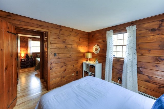 bedroom with wooden walls and wood finished floors