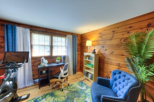 home office featuring wooden walls and light wood finished floors