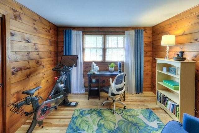 office space with wooden walls and light wood-style floors