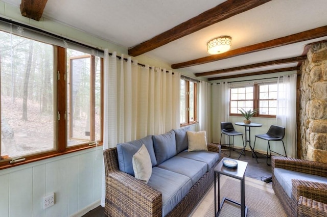 living area with beamed ceiling