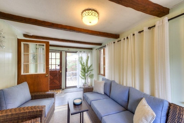 living room with beam ceiling and wood finished floors